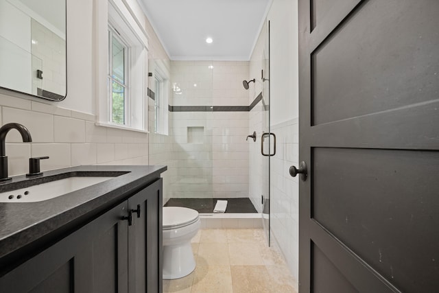 bathroom with tile walls, crown molding, toilet, and vanity