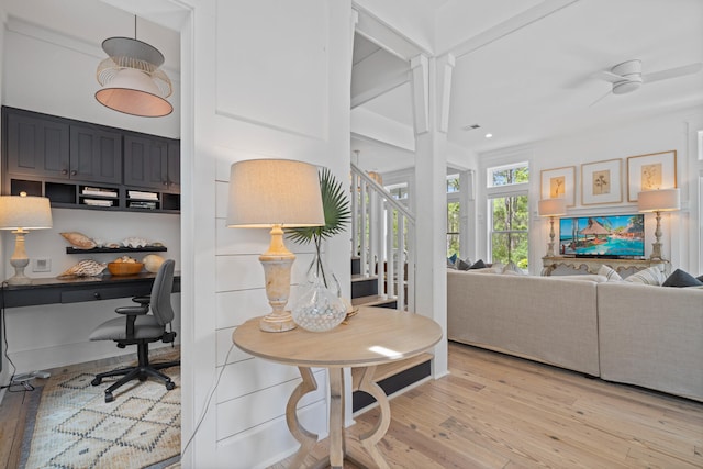 interior space with light hardwood / wood-style floors, ceiling fan, and built in desk