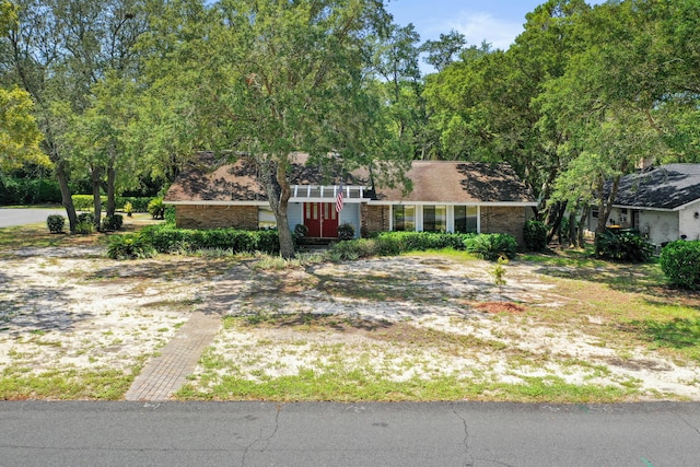 mid-century home with brick siding