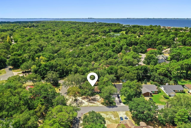 aerial view with a water view and a forest view