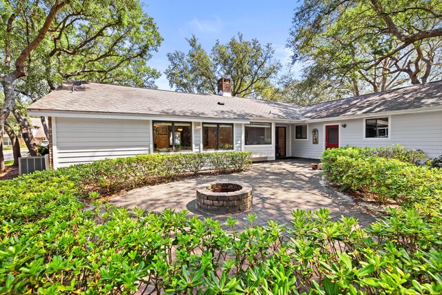 back of house with a patio area, central air condition unit, and a fire pit