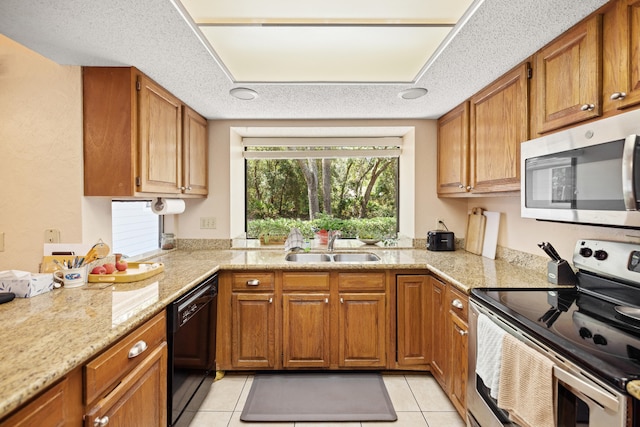 kitchen featuring sink, a textured ceiling, light tile patterned floors, and stainless steel appliances