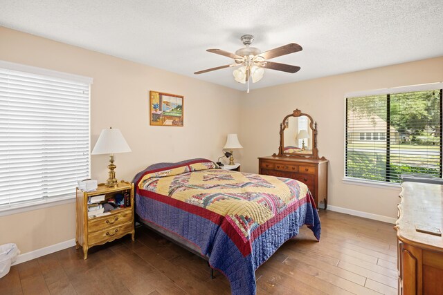 bedroom featuring a textured ceiling, ceiling fan, and wood-type flooring