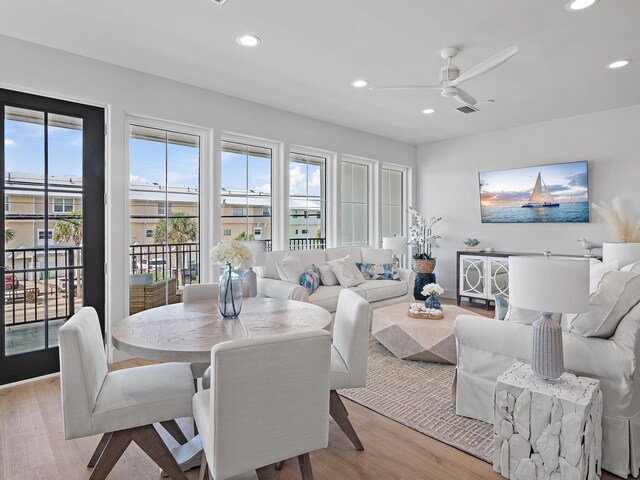 dining space featuring a healthy amount of sunlight, ceiling fan, and light wood-type flooring