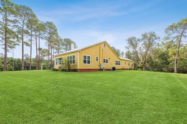 rear view of house featuring a yard