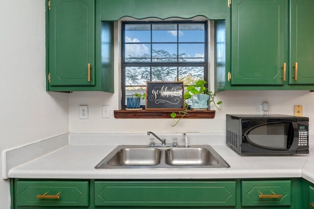 kitchen with green cabinetry and sink