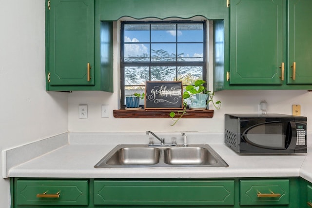 5793 New York St, Baker, FL 32531 - kitchen featuring a sink, light countertops, black microwave, and green cabinetry
