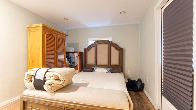 bedroom with hardwood / wood-style flooring