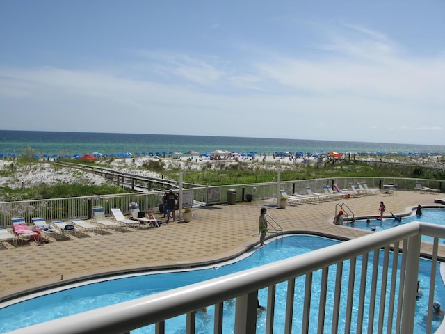 view of swimming pool with a water view