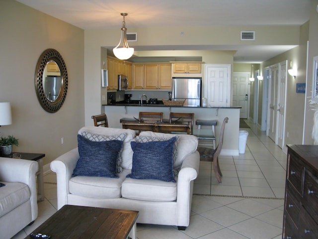 living room with sink and light tile patterned flooring