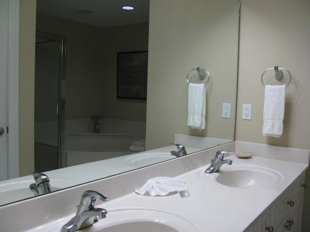 bathroom with walk in shower, vanity, and toilet