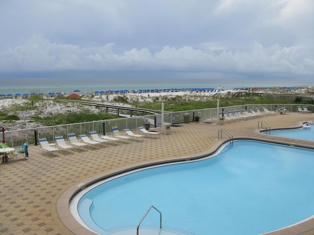 view of swimming pool with a water view