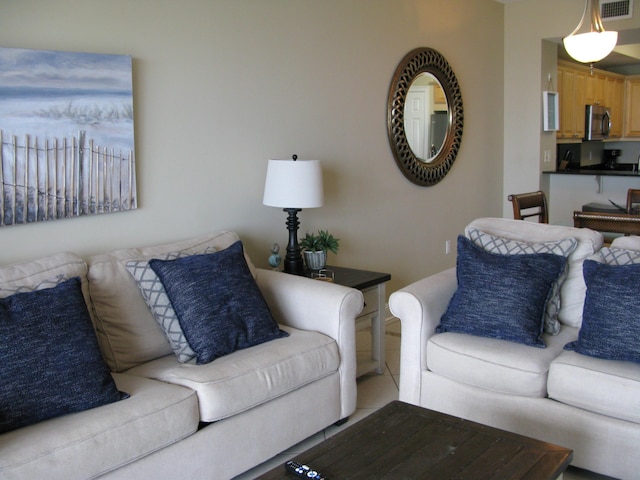 living room with light tile patterned flooring