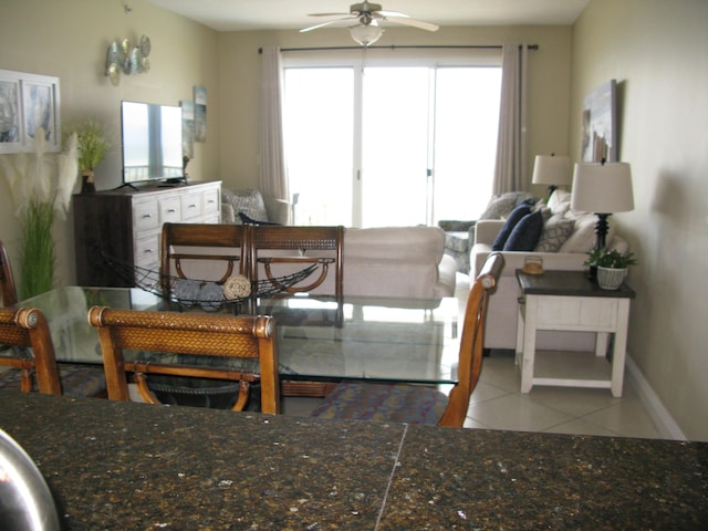 living room with ceiling fan and light tile patterned floors