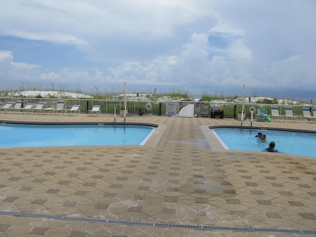 view of swimming pool with a patio area