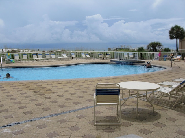 view of swimming pool with a patio