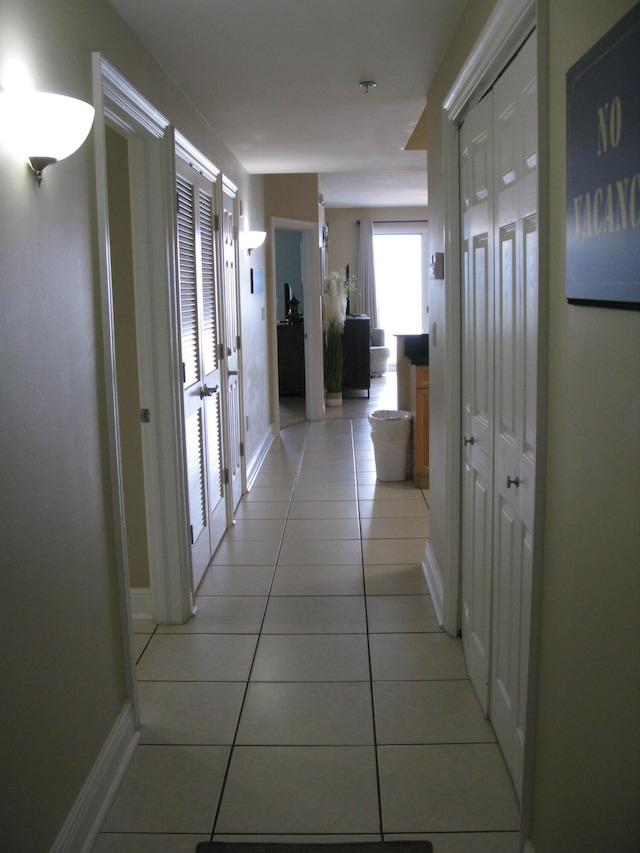 hall with light tile patterned floors