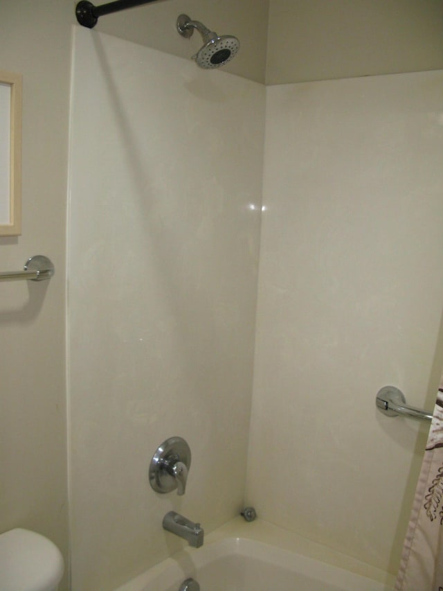 bathroom with shower / bath combination with curtain and toilet