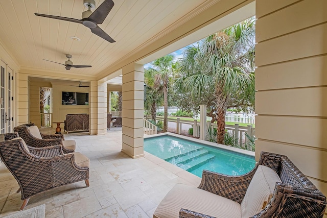 outdoor pool with a patio, fence, and ceiling fan