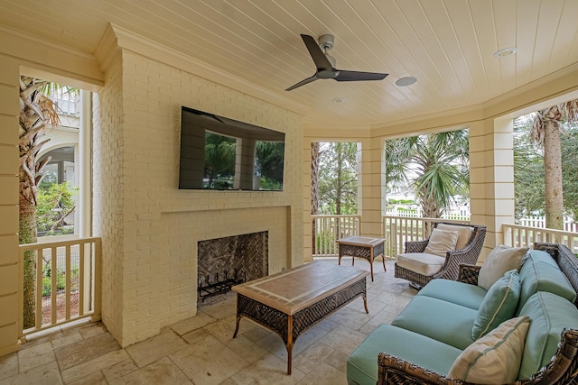 sunroom featuring a fireplace, wood ceiling, and a wealth of natural light