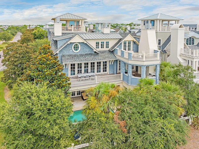 rear view of property featuring a standing seam roof, a gazebo, french doors, a residential view, and metal roof