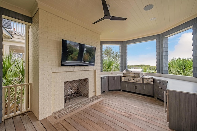 deck with area for grilling, a grill, and a ceiling fan