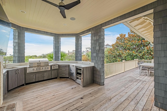 deck with a grill, a ceiling fan, and a sink