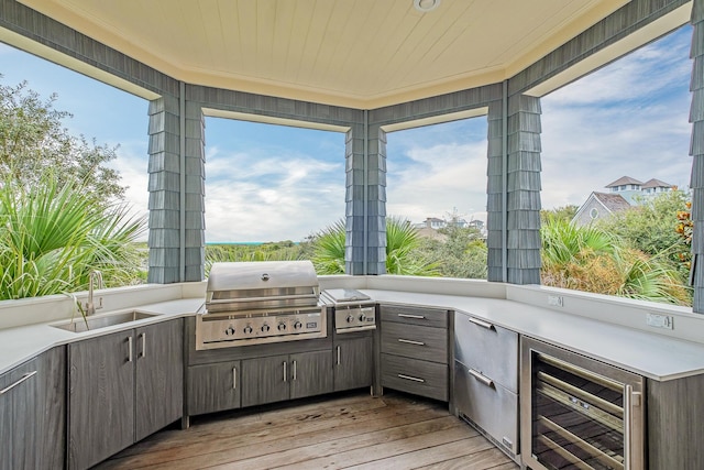 view of patio / terrace with wine cooler, area for grilling, exterior kitchen, and a sink