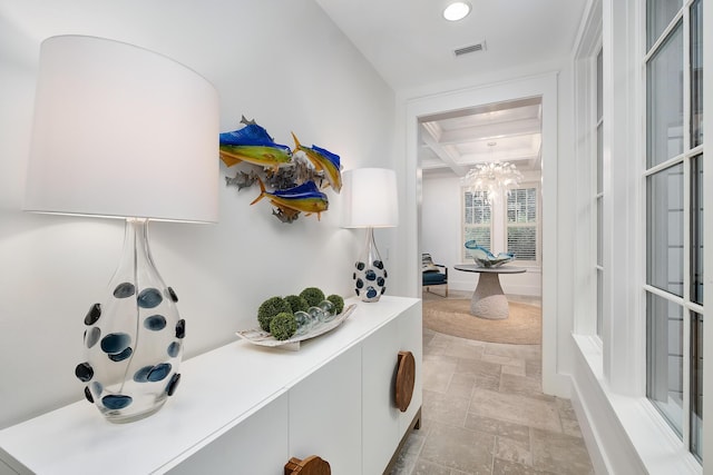 hallway with visible vents, beam ceiling, stone finish floor, coffered ceiling, and recessed lighting