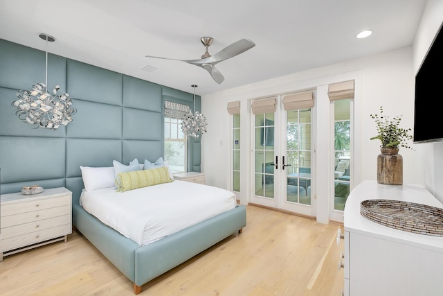 bedroom with visible vents, french doors, light wood-style floors, and access to outside