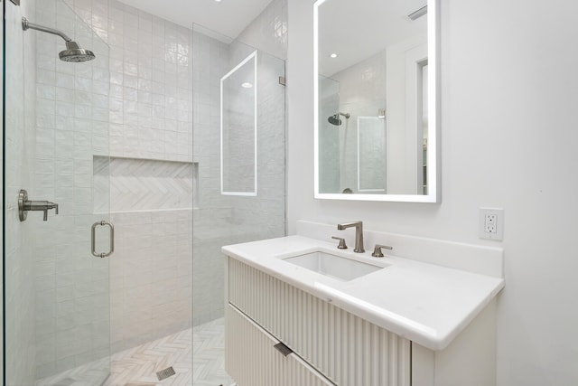 full bathroom featuring a shower stall, visible vents, and a sink