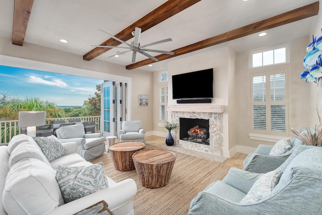 living room with beam ceiling, wood finished floors, recessed lighting, a fireplace, and baseboards