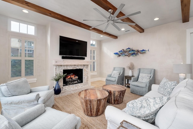 living area with visible vents, beamed ceiling, recessed lighting, a fireplace, and a ceiling fan