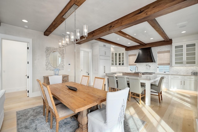 dining area with beam ceiling, recessed lighting, baseboards, and light wood-style floors