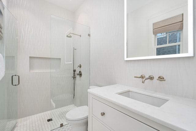 full bathroom with vanity, toilet, and a stall shower