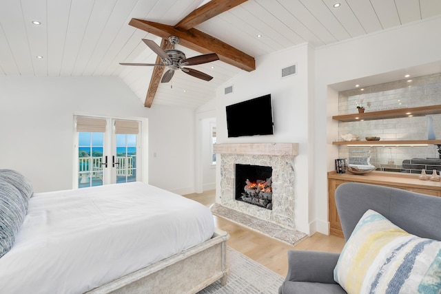 bedroom with visible vents, lofted ceiling with beams, wood finished floors, wood ceiling, and access to exterior