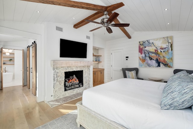 bedroom featuring visible vents, lofted ceiling with beams, a high end fireplace, light wood finished floors, and wood ceiling