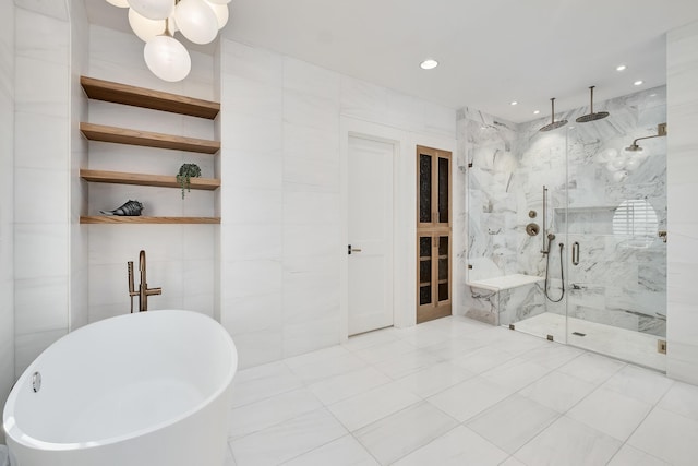 bathroom featuring tile walls, a freestanding tub, recessed lighting, and a marble finish shower