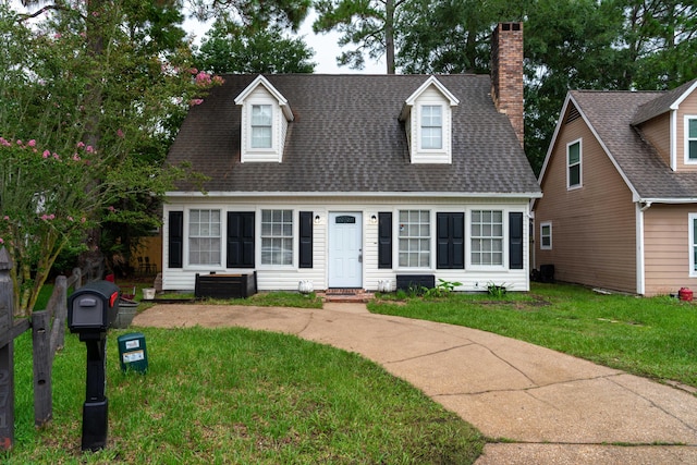 new england style home featuring a front lawn