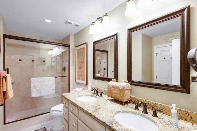 bathroom with vanity, tile patterned floors, a shower with door, and toilet