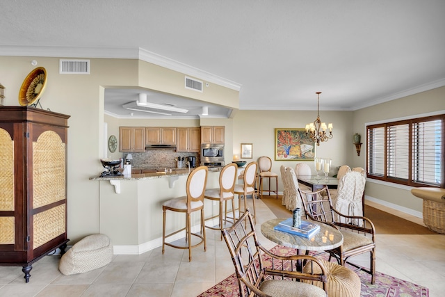 dining room with a notable chandelier, crown molding, and light tile patterned flooring