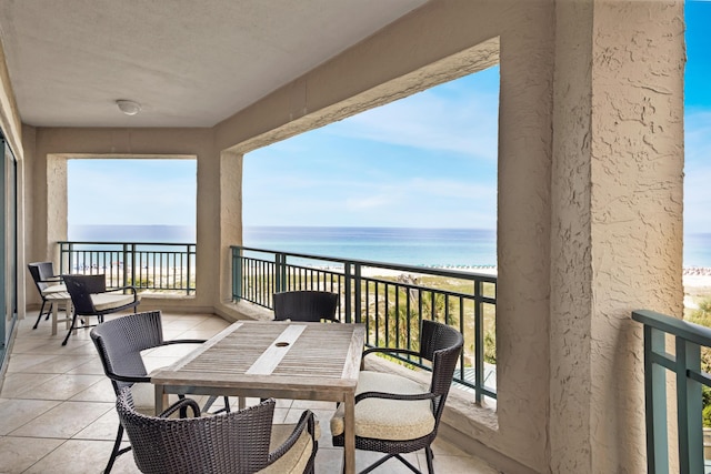 balcony with a water view and a beach view