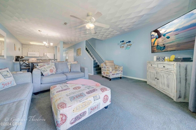 carpeted living room featuring ceiling fan with notable chandelier