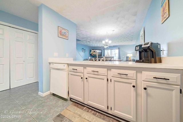 kitchen with pendant lighting, light tile patterned floors, white cabinetry, a chandelier, and dishwasher