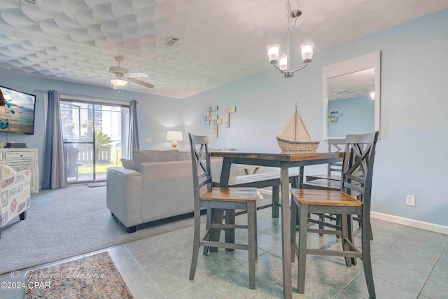 dining room featuring light tile patterned flooring and ceiling fan with notable chandelier