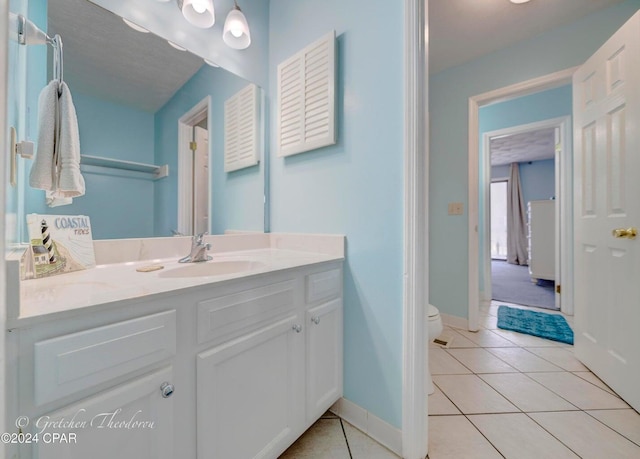 bathroom with vanity, toilet, and tile patterned floors