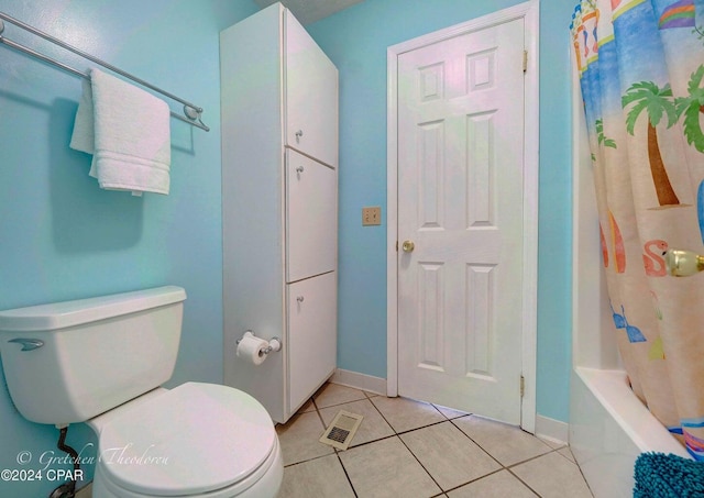 bathroom featuring shower / tub combo, tile patterned floors, and toilet