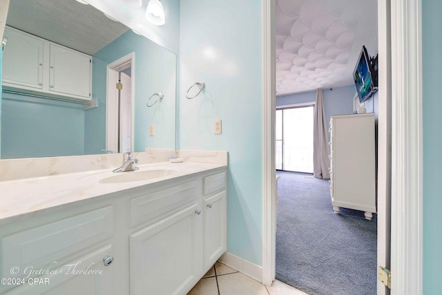 bathroom featuring tile patterned flooring and vanity