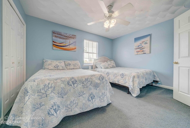 carpeted bedroom featuring a closet and ceiling fan