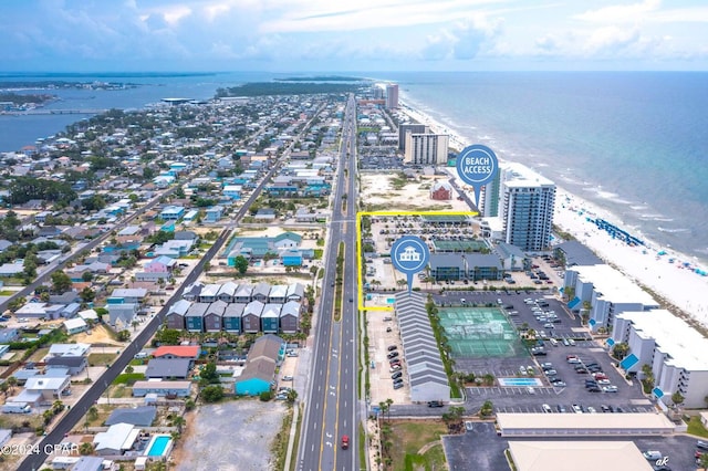 aerial view with a water view and a beach view